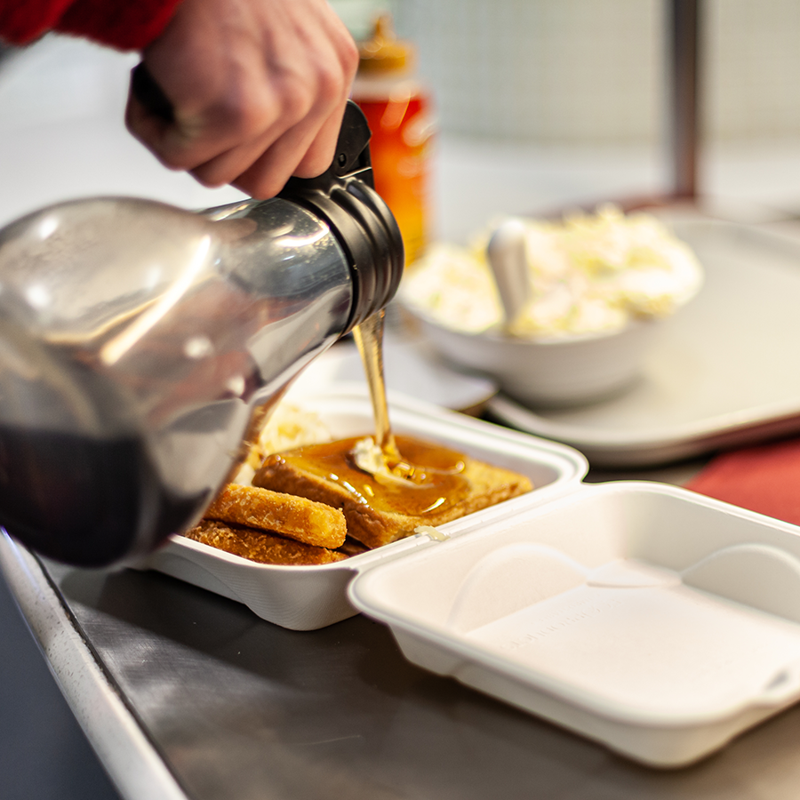 Syrup being poured on French toast. 